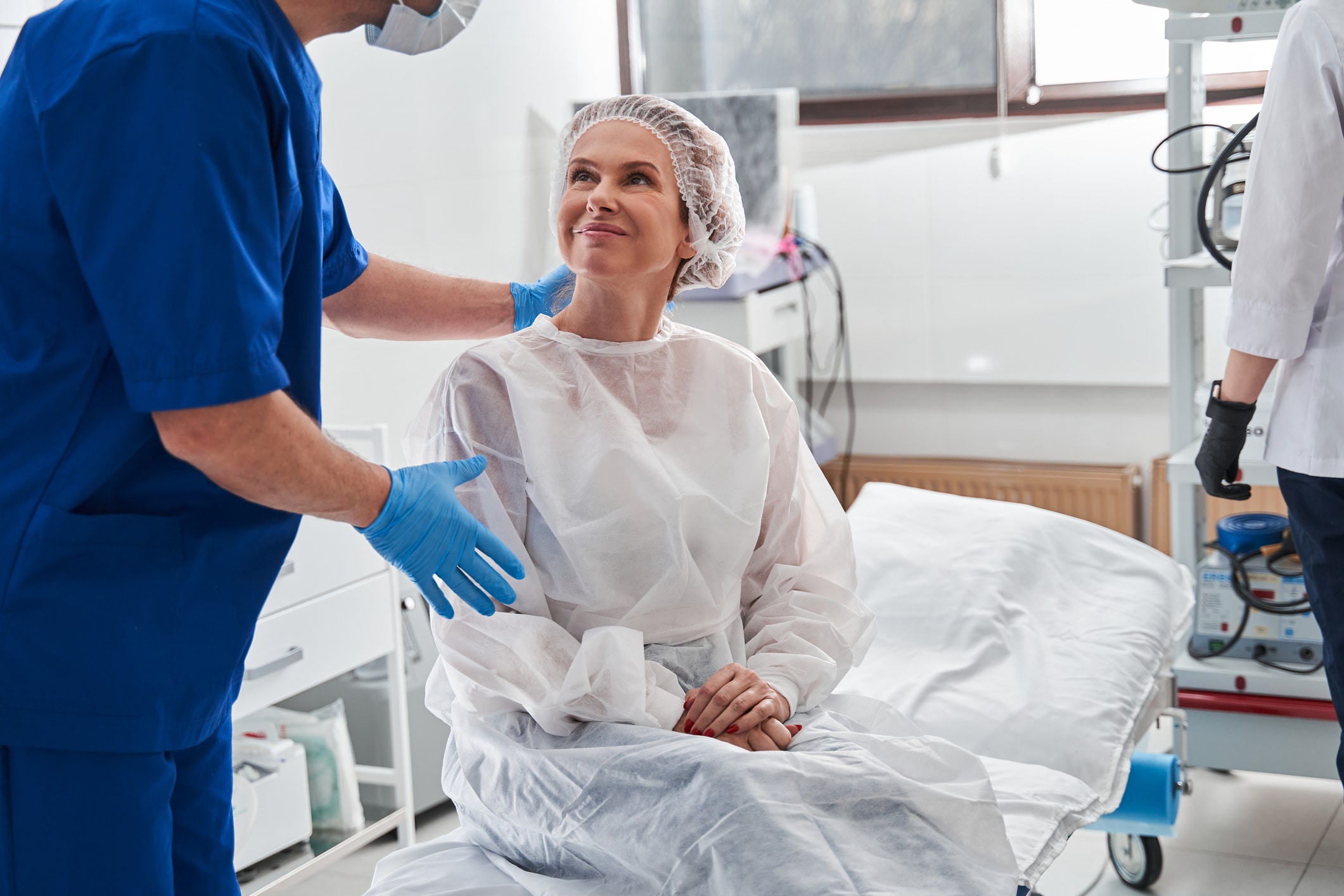 woman in a hospital gown getting ready for surgery