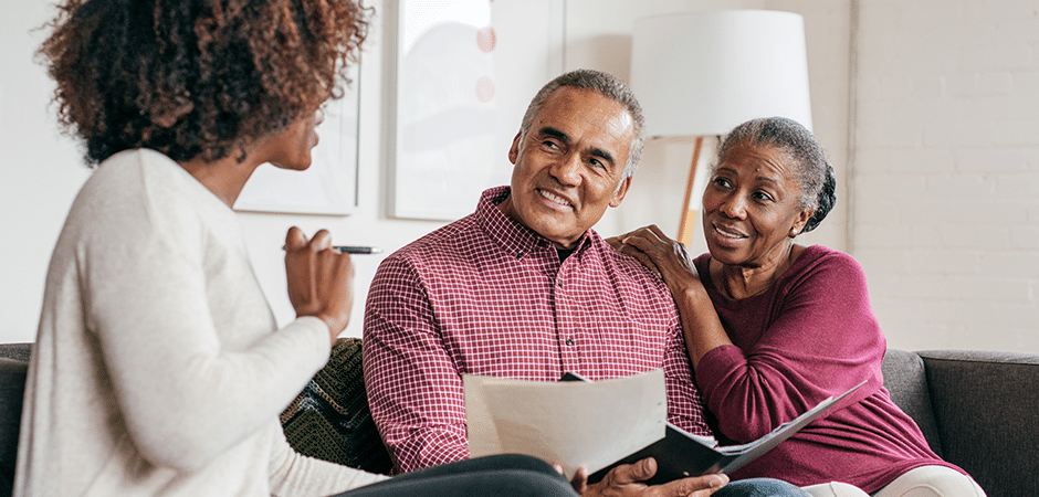 couple on couch talking to their doctor